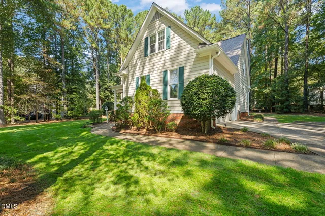 a view of backyard of house with green space