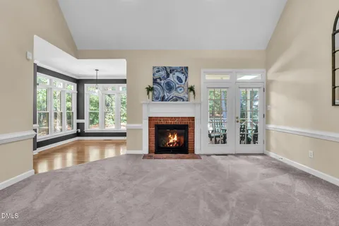 a view of an empty room with a fireplace and a window