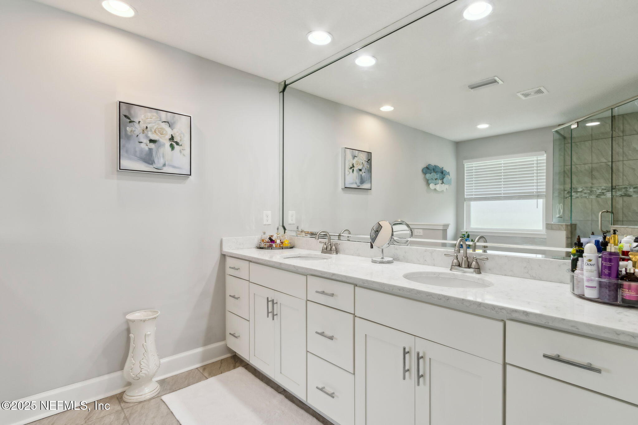 75652 Edwards Road Yulee, FL 32097 - Photo 12 of 26 a bathroom with double vanity sink a mirror and a shower