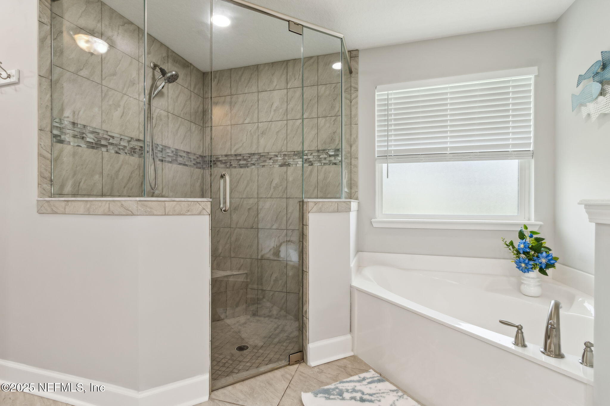 75652 Edwards Road Yulee, FL 32097 - Photo 13 of 26 a bathroom with a bathtub and a shower