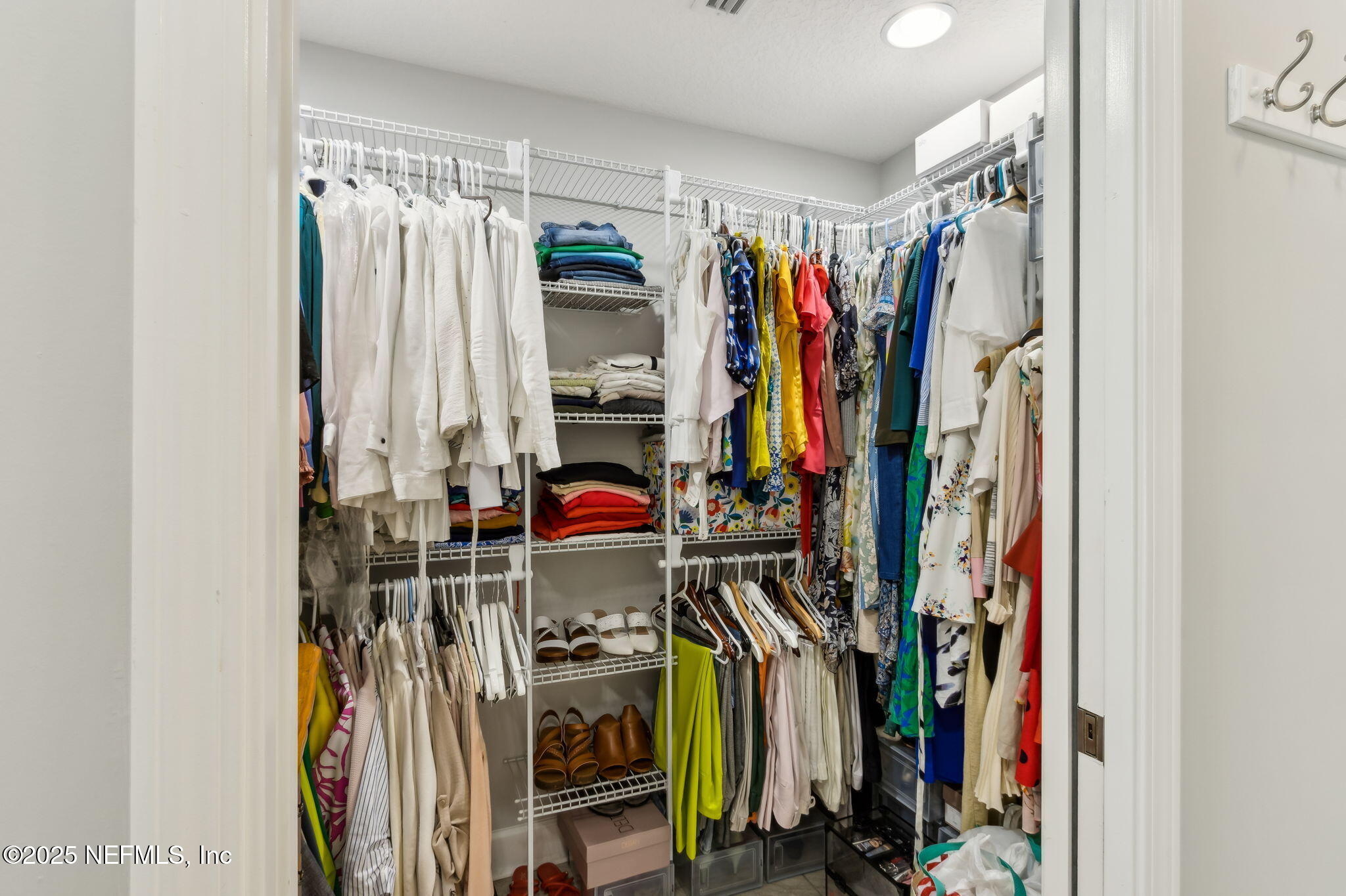 75652 Edwards Road Yulee, FL 32097 - Photo 14 of 26 a view of walk in closet with clothes
