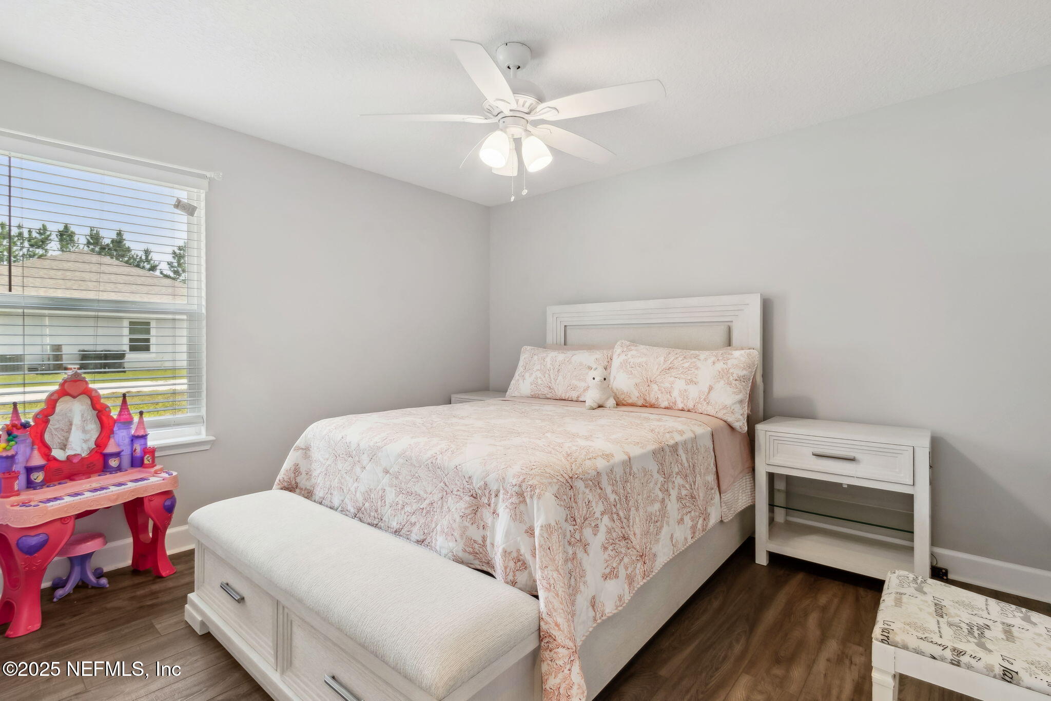 75652 Edwards Road Yulee, FL 32097 - Photo 16 of 26 a bedroom with a bed and a chandelier