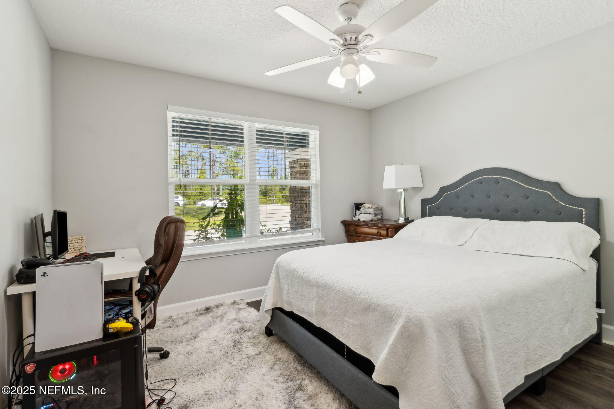 75652 Edwards Road Yulee, FL 32097 - Photo 18 of 26 a bedroom with a bed a desk and chair