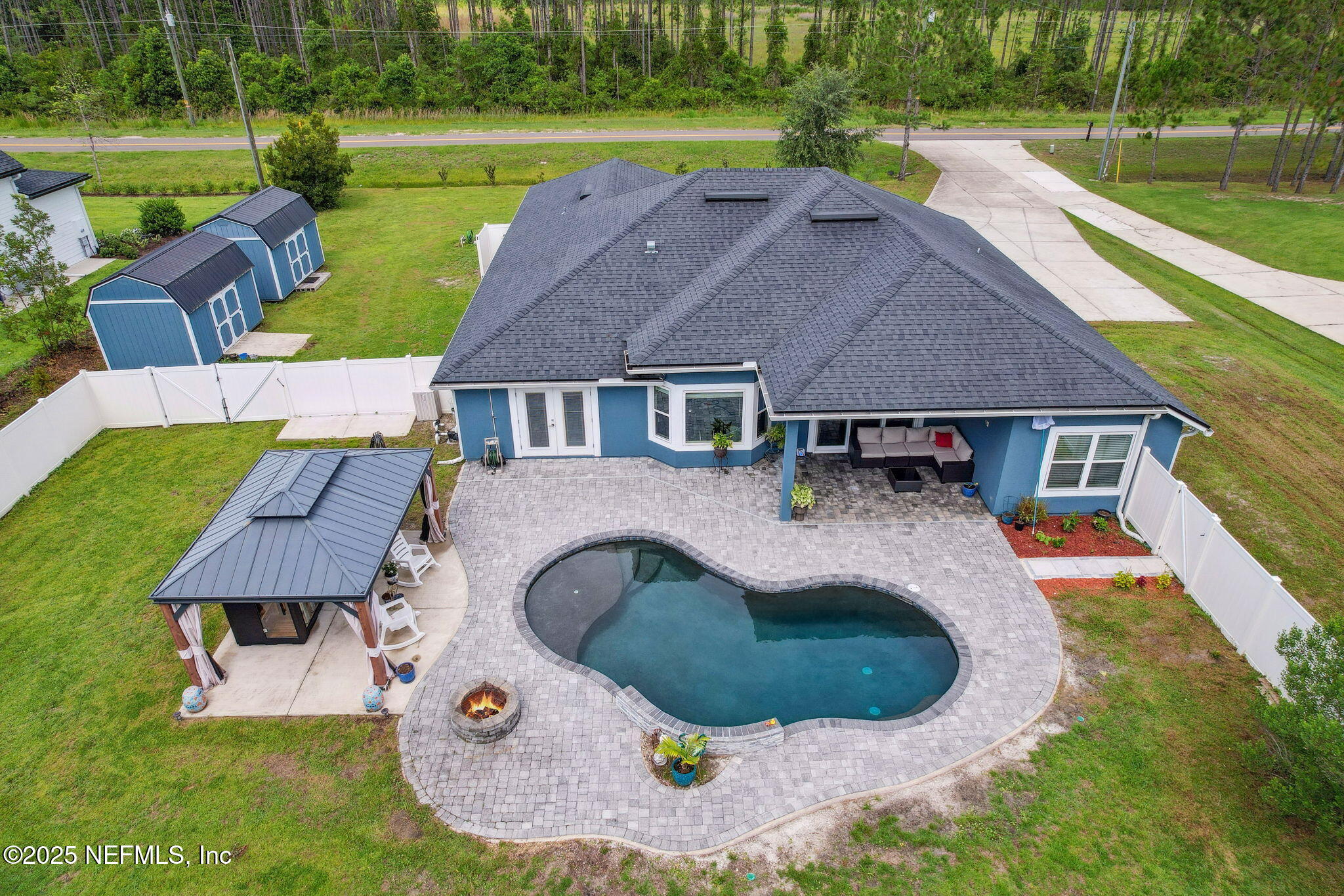 75652 Edwards Road Yulee, FL 32097 - Photo 2 of 26 an aerial view of a house with outdoor space and swimming pool