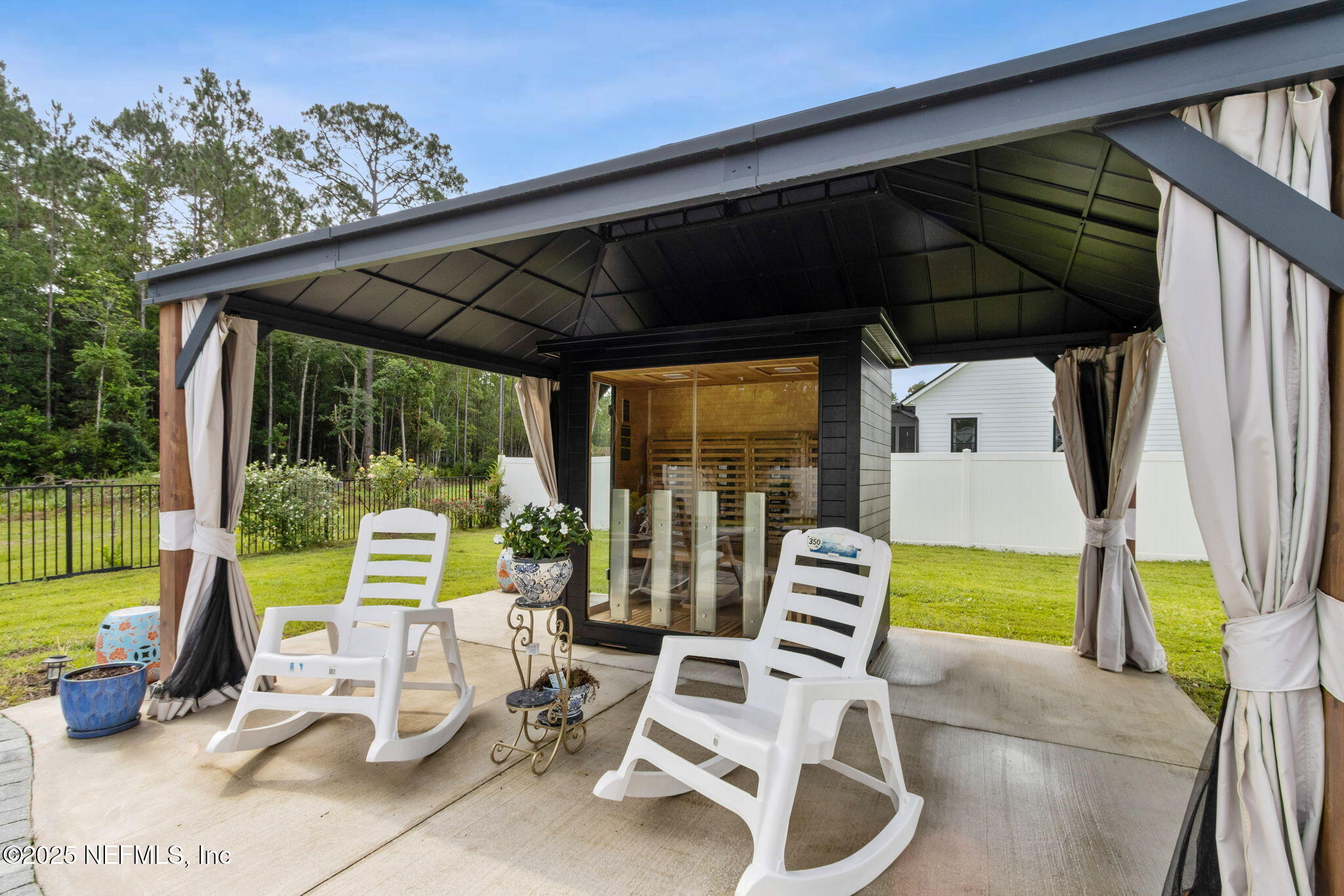 75652 Edwards Road Yulee, FL 32097 - Photo 21 of 26 a view of a patio with a table chairs and a backyard