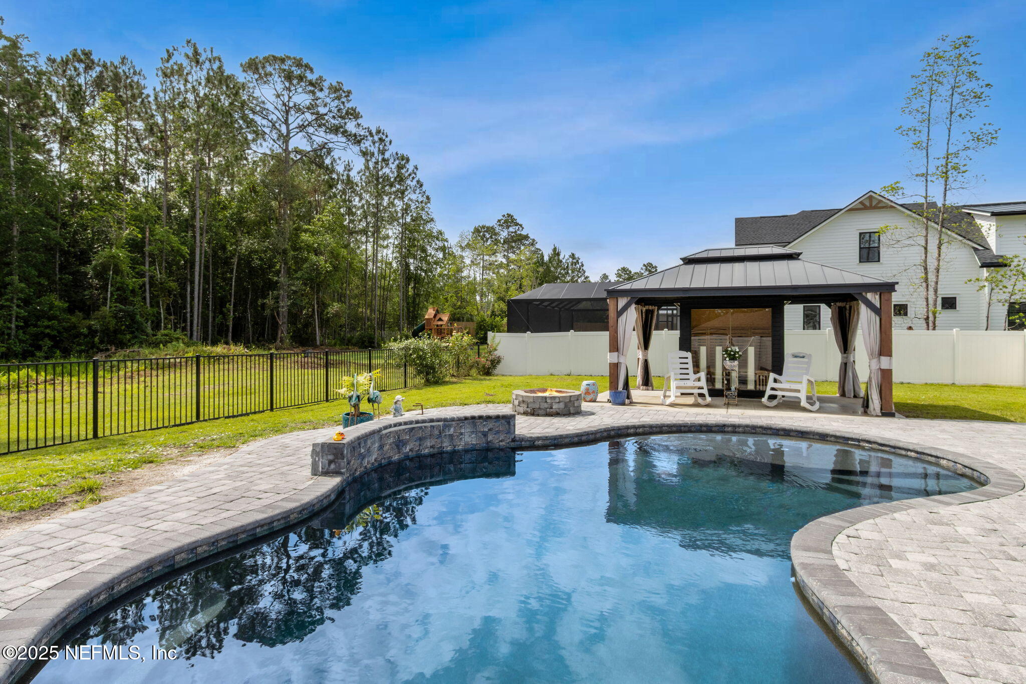 75652 Edwards Road Yulee, FL 32097 - Photo 22 of 26 a view of a swimming pool with a patio