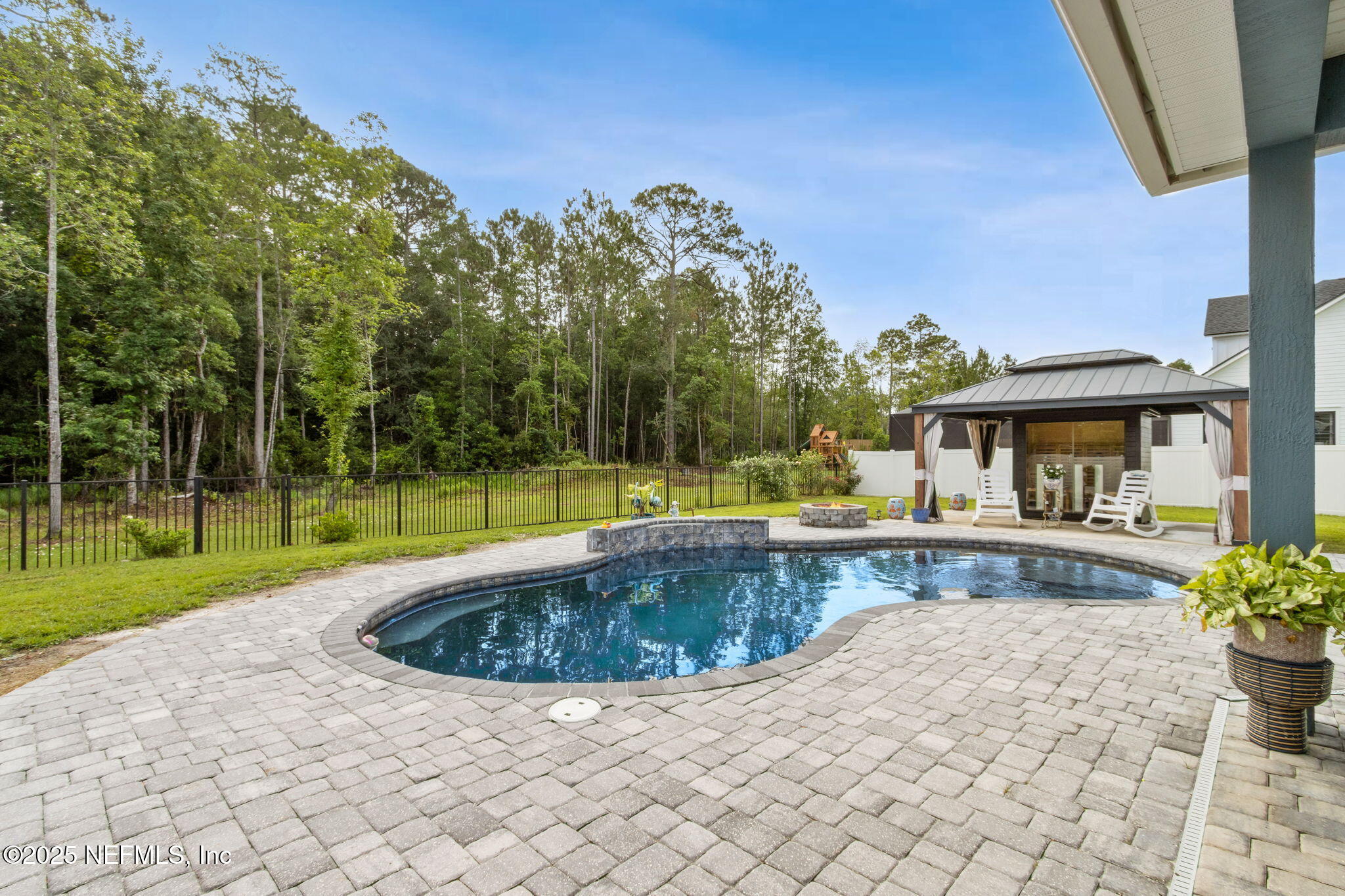 75652 Edwards Road Yulee, FL 32097 - Photo 4 of 26 a view of a swimming pool with a patio