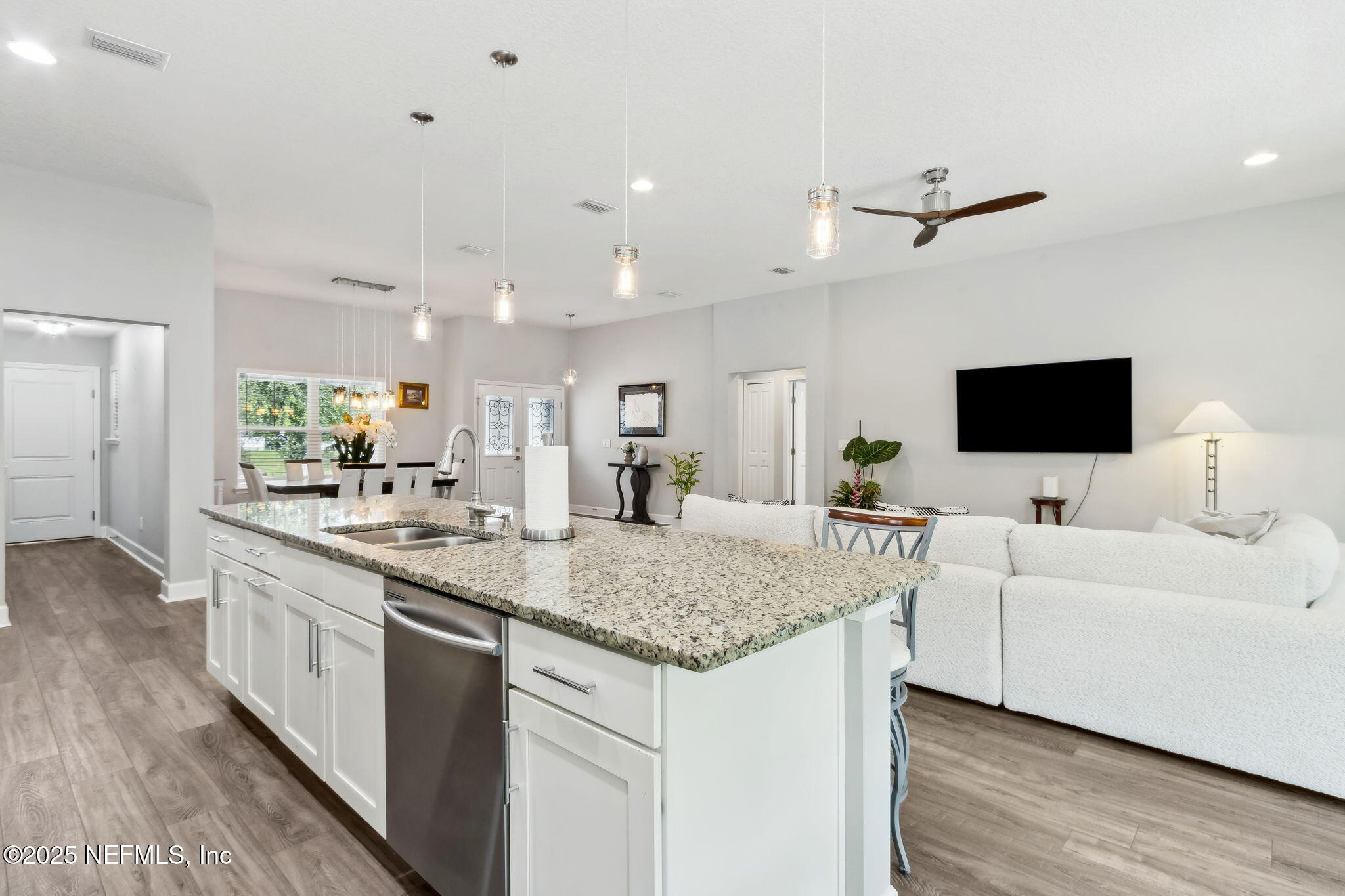 75652 Edwards Road Yulee, FL 32097 - Photo 8 of 26 a view of living room with granite countertop furniture and flat screen tv