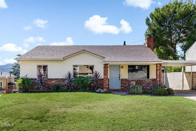 a view of a house with garden and plants