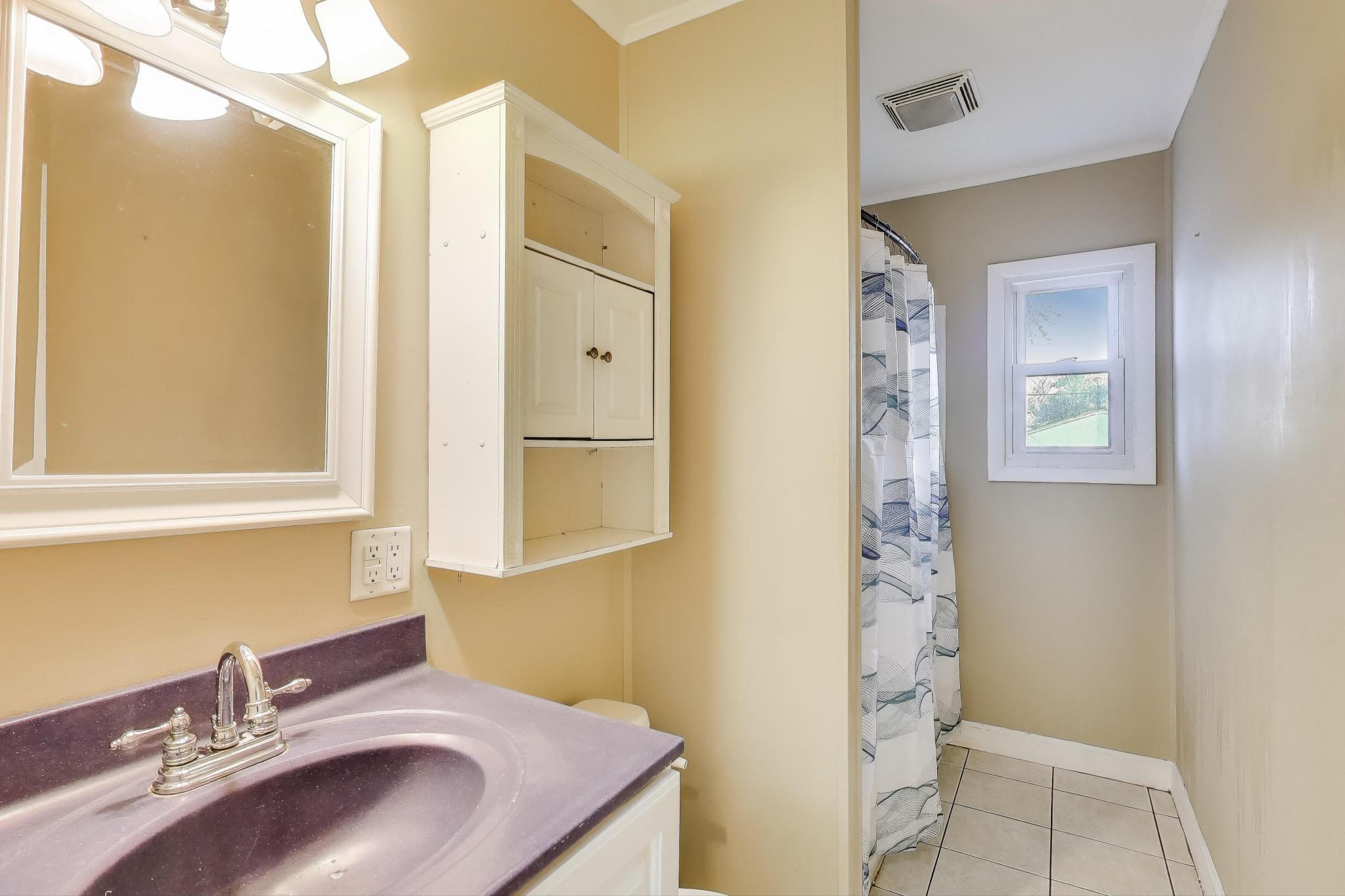 1213 North Jay Avenue Griffith, IN 46319 - Photo 14 of 36 a bathroom with a sink and a mirror