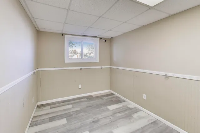 a view of an empty room with closet and a window