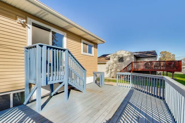 a view of a roof deck with wooden floor and fence