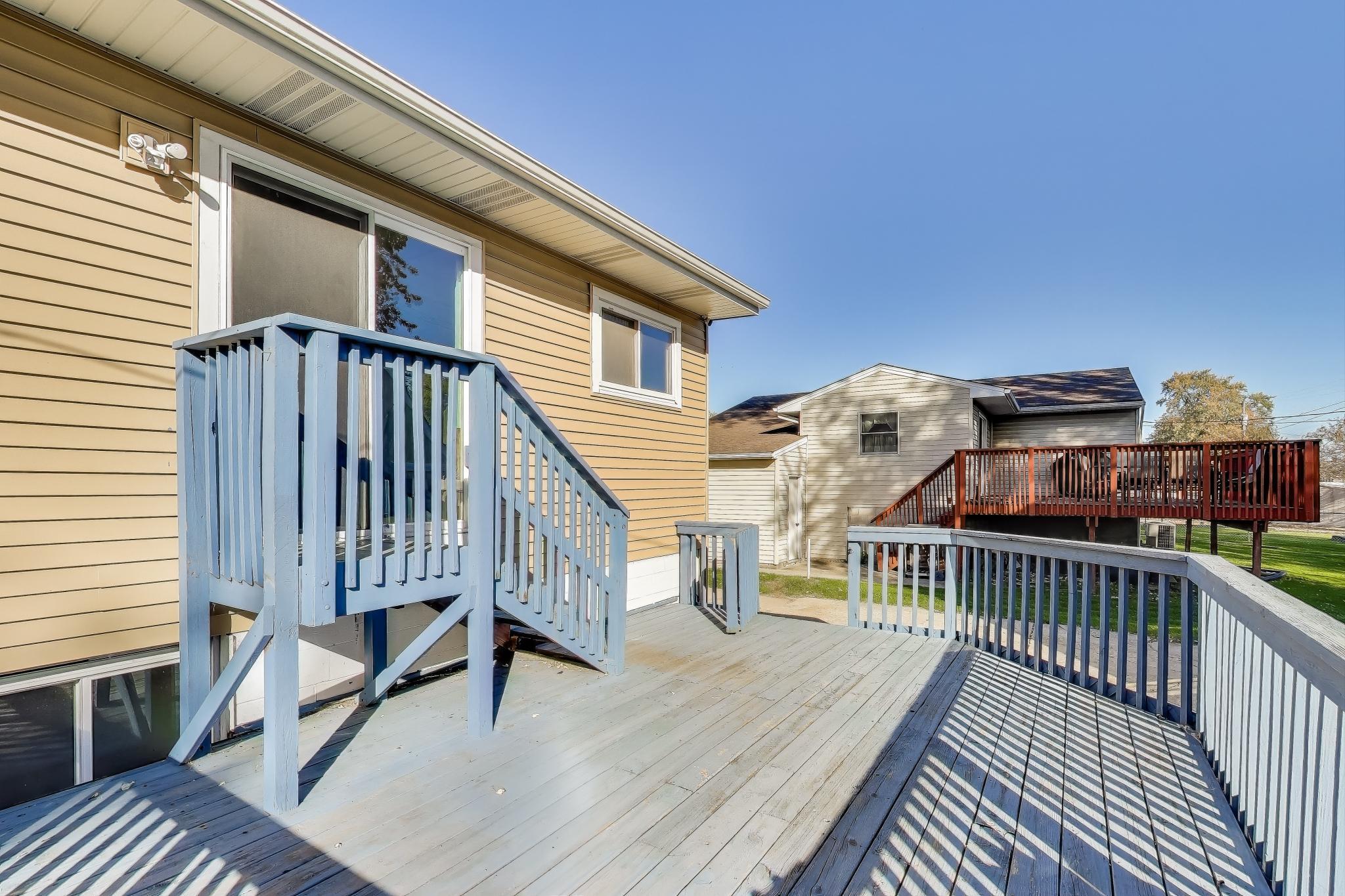 1213 North Jay Avenue Griffith, IN 46319 - Photo 21 of 36 a view of a roof deck with wooden floor and fence