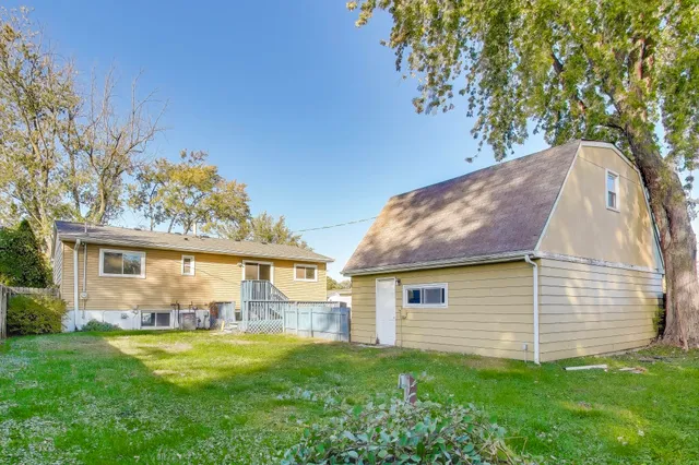a view of backyard of house with green space