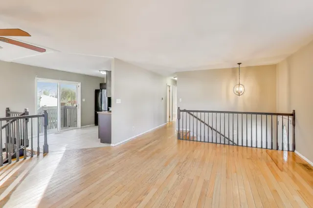 a view of a room with wooden floor