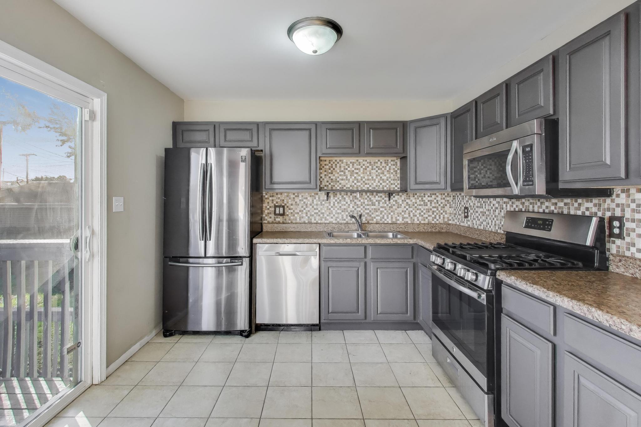 1213 North Jay Avenue Griffith, IN 46319 - Photo 6 of 36 a kitchen with a stove a refrigerator and a sink