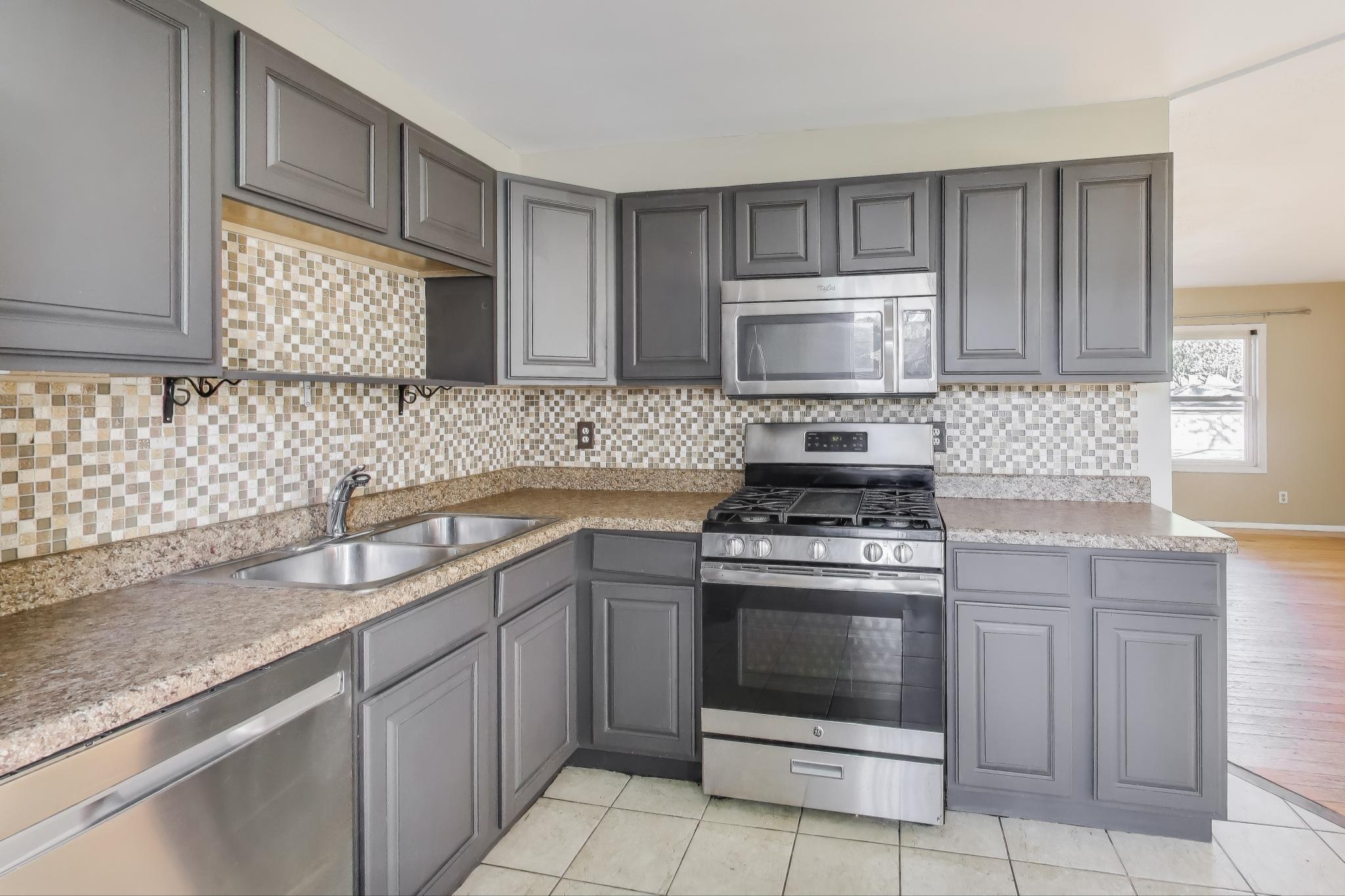 1213 North Jay Avenue Griffith, IN 46319 - Photo 7 of 36 a kitchen with cabinets appliances and a sink