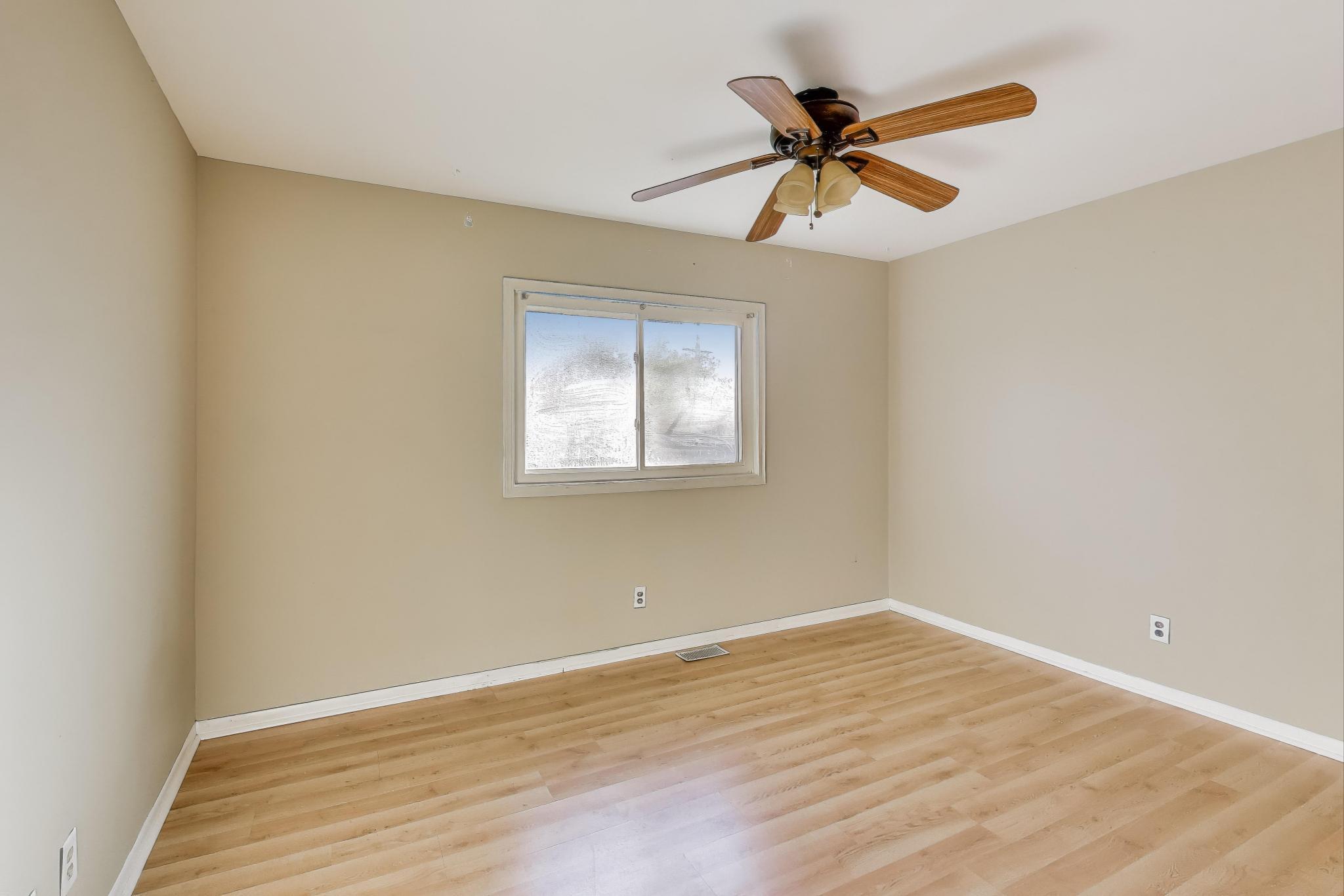 1213 North Jay Avenue Griffith, IN 46319 - Photo 8 of 36 a view of empty room with wooden floor and ceiling fan