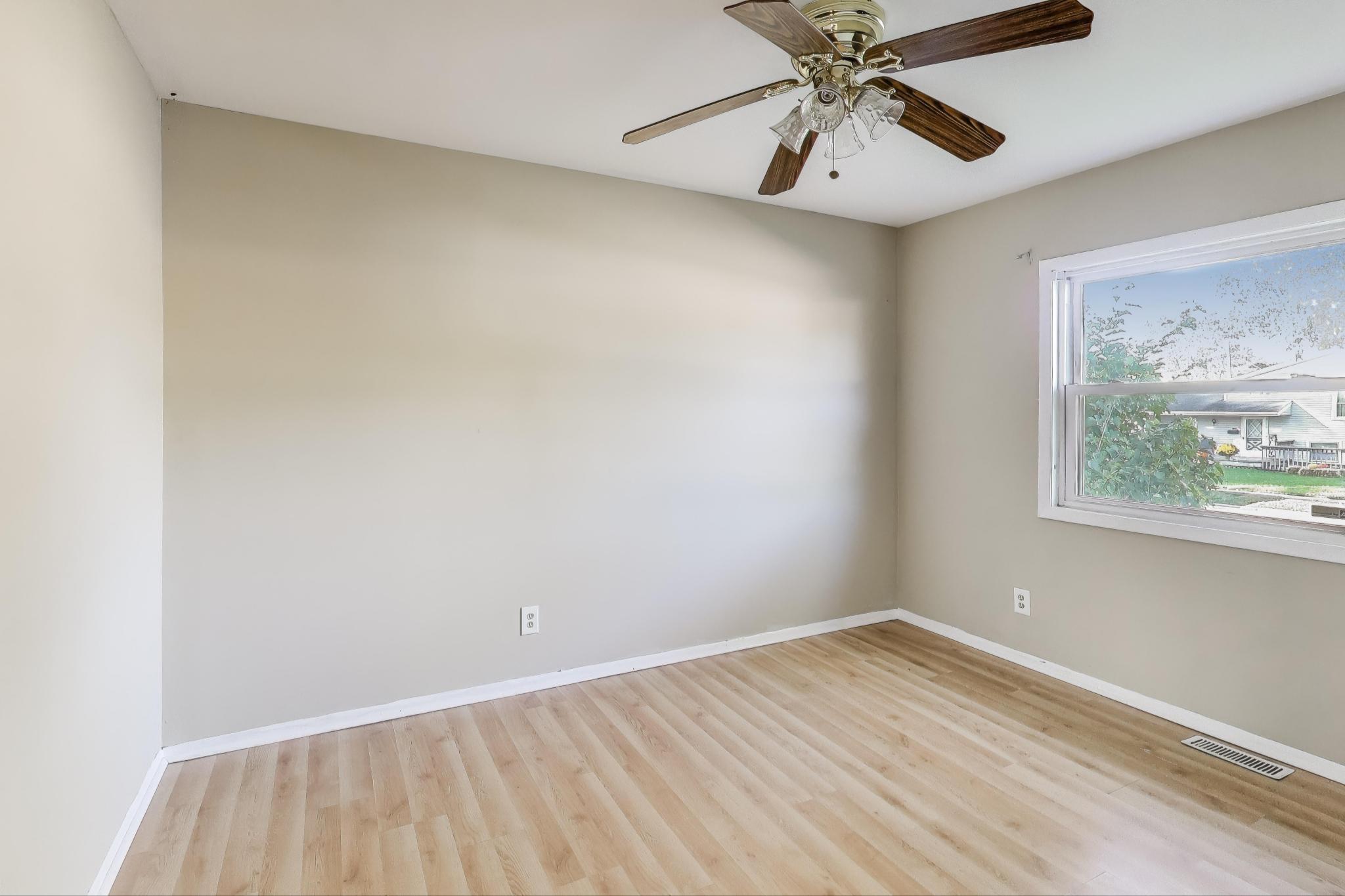 1213 North Jay Avenue Griffith, IN 46319 - Photo 10 of 36 an empty room with a window and a ceiling fan
