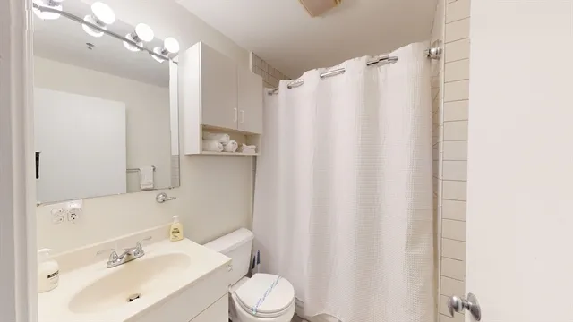 a bathroom with a sink toilet and shower