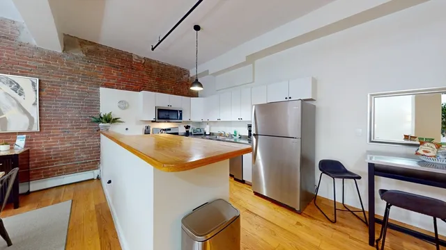 a kitchen that has a cabinets a sink and a refrigerator