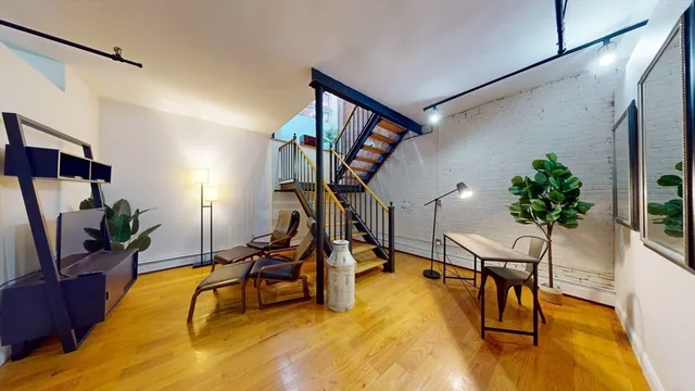 a view of a livingroom with furniture and a gym equipment