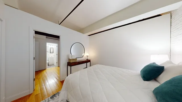 a bedroom with a bed and lamps