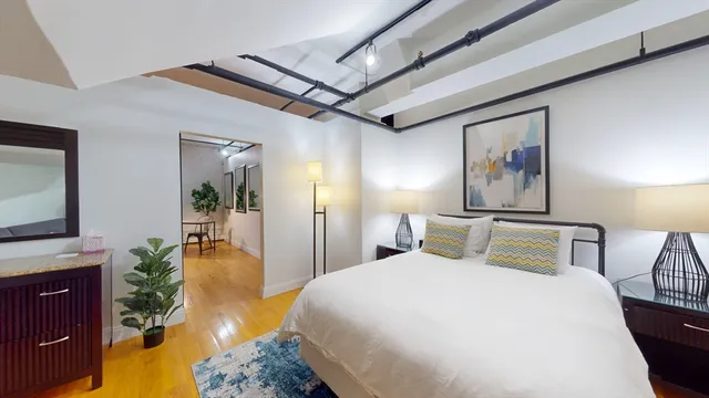 a bedroom with a bed and a flat screen tv