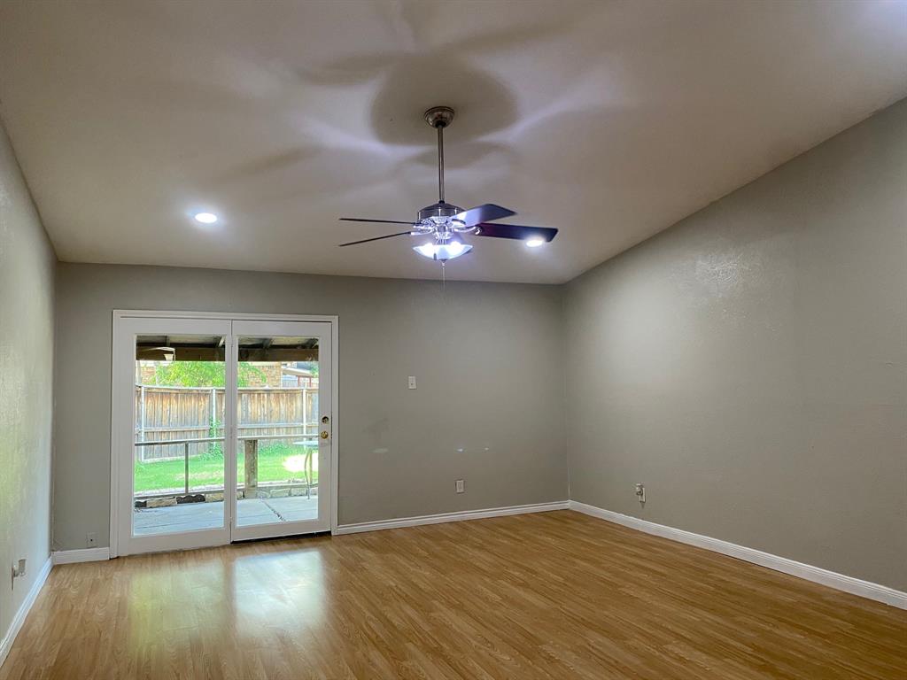 1109 Cross Bend Road Plano, TX 75023 - Photo 6 of 11 Spacious interior featuring wood-finish flooring, recessed lighting, and a ceiling fan with integrated illumination