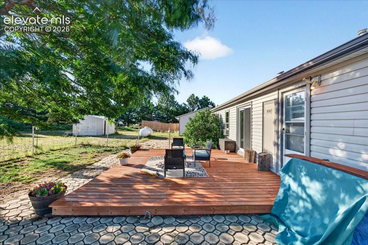 6210 Prospero Road Peyton, CO 80831 - Photo 17 of 26 Backyard and deck