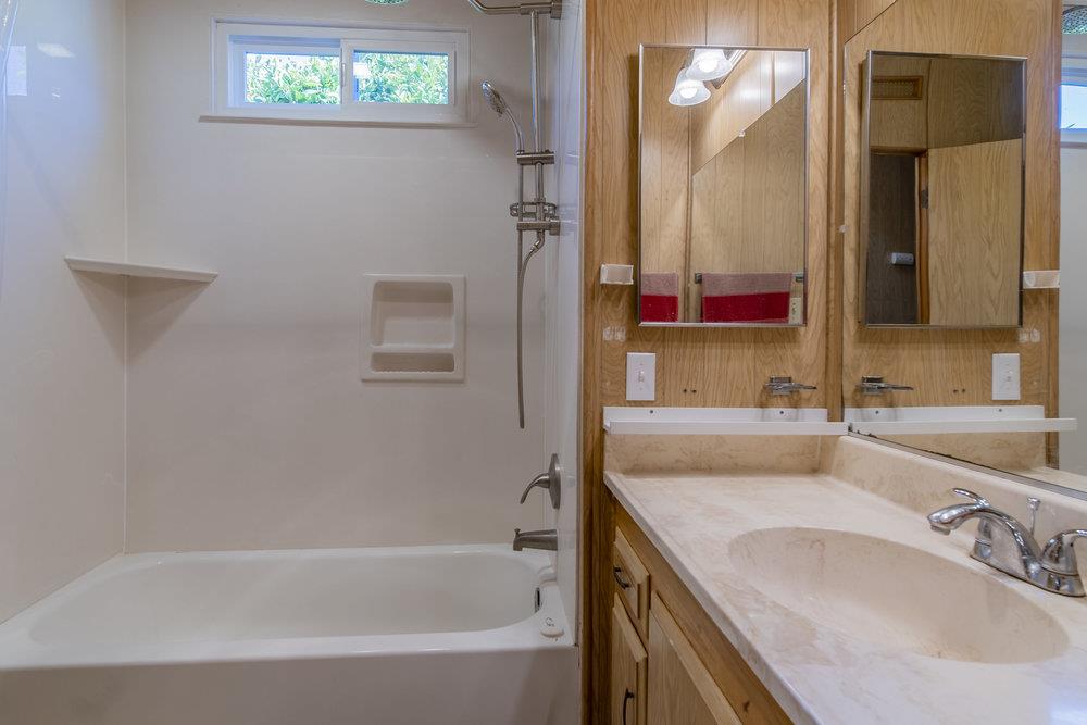 4300 Soquel Drive, Unit 220 Soquel, CA 95073 - Photo 14 of 24 a bathroom with a granite countertop sink and a mirror