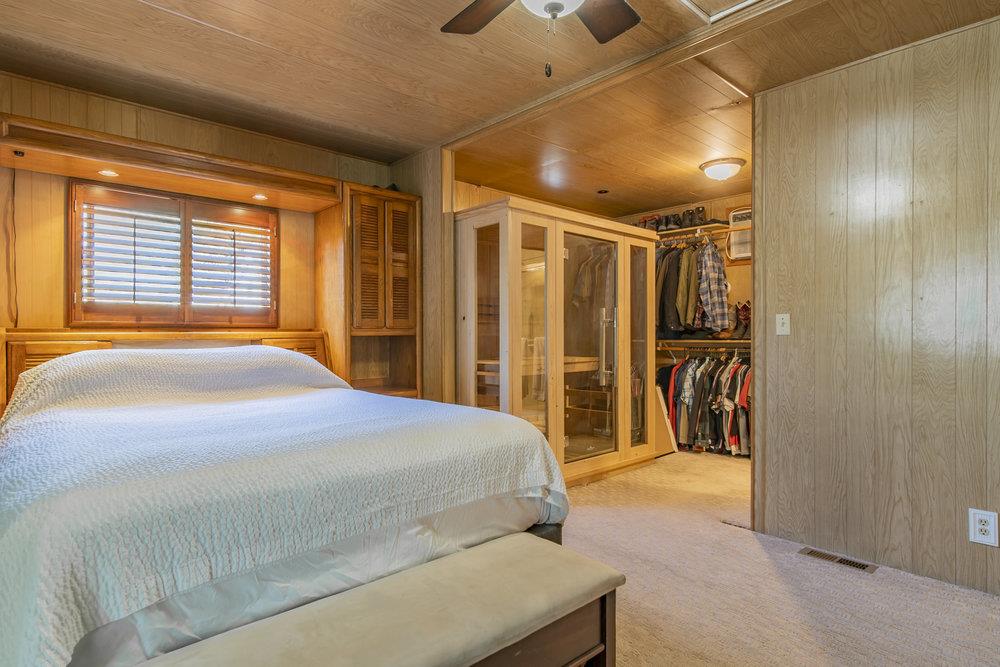 4300 Soquel Drive, Unit 220 Soquel, CA 95073 - Photo 16 of 24 a bedroom with a large bed and a chandelier