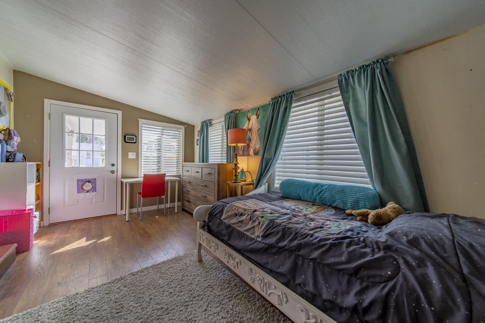 4300 Soquel Drive, Unit 220 Soquel, CA 95073 - Photo 19 of 24 a bedroom with a bed couch and windows