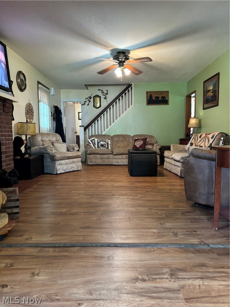 52 Old Dutch Ridge Road Parkersburg, WV 26104 - Photo 3 of 9 Living room with a brick fireplace, ceiling fan, and hardwood / wood-style floors