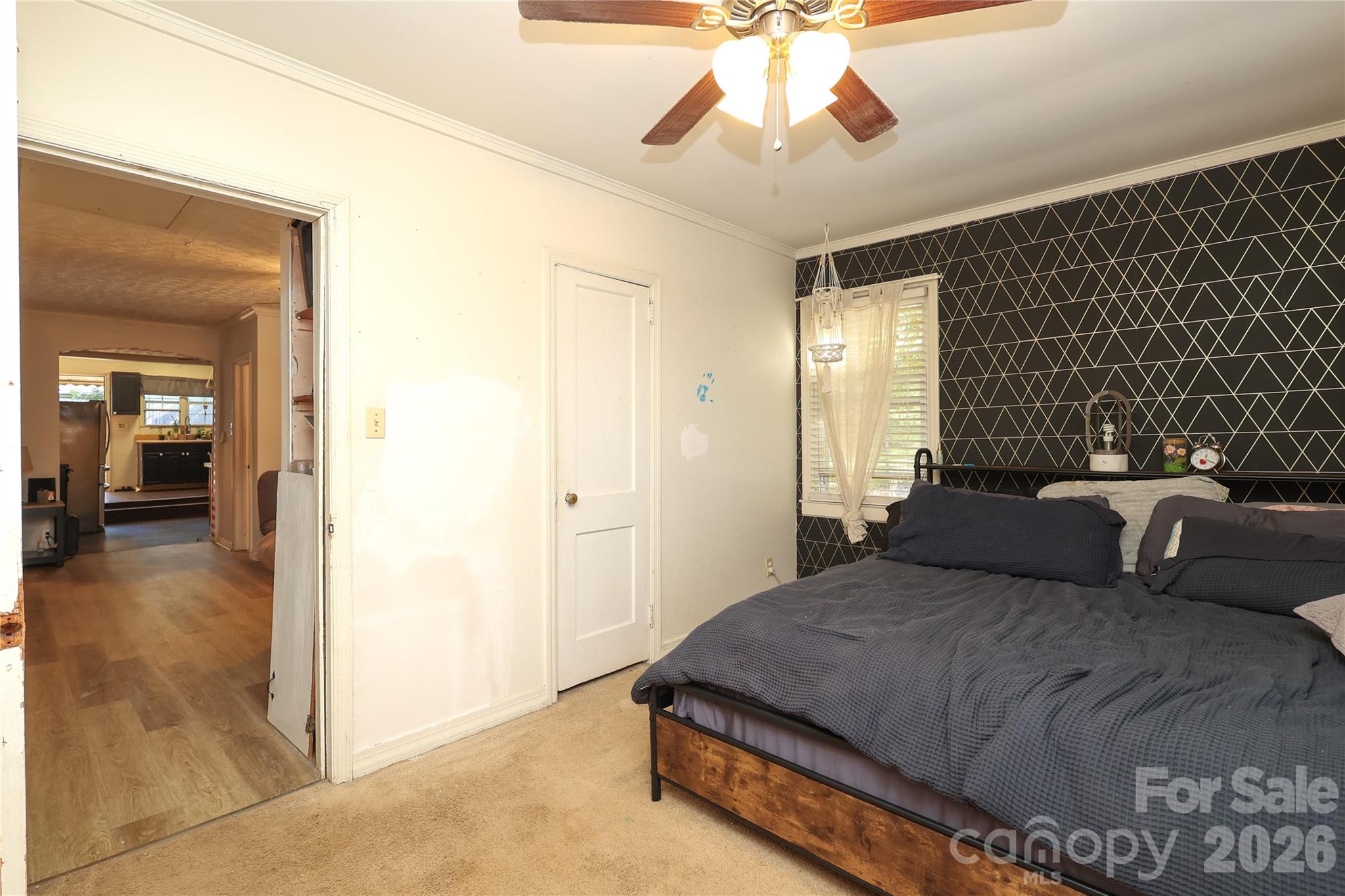 1324 State Rd S-29-496 Lancaster, SC 29720 - Photo 25 of 28 a bedroom with a bed and a chandelier
