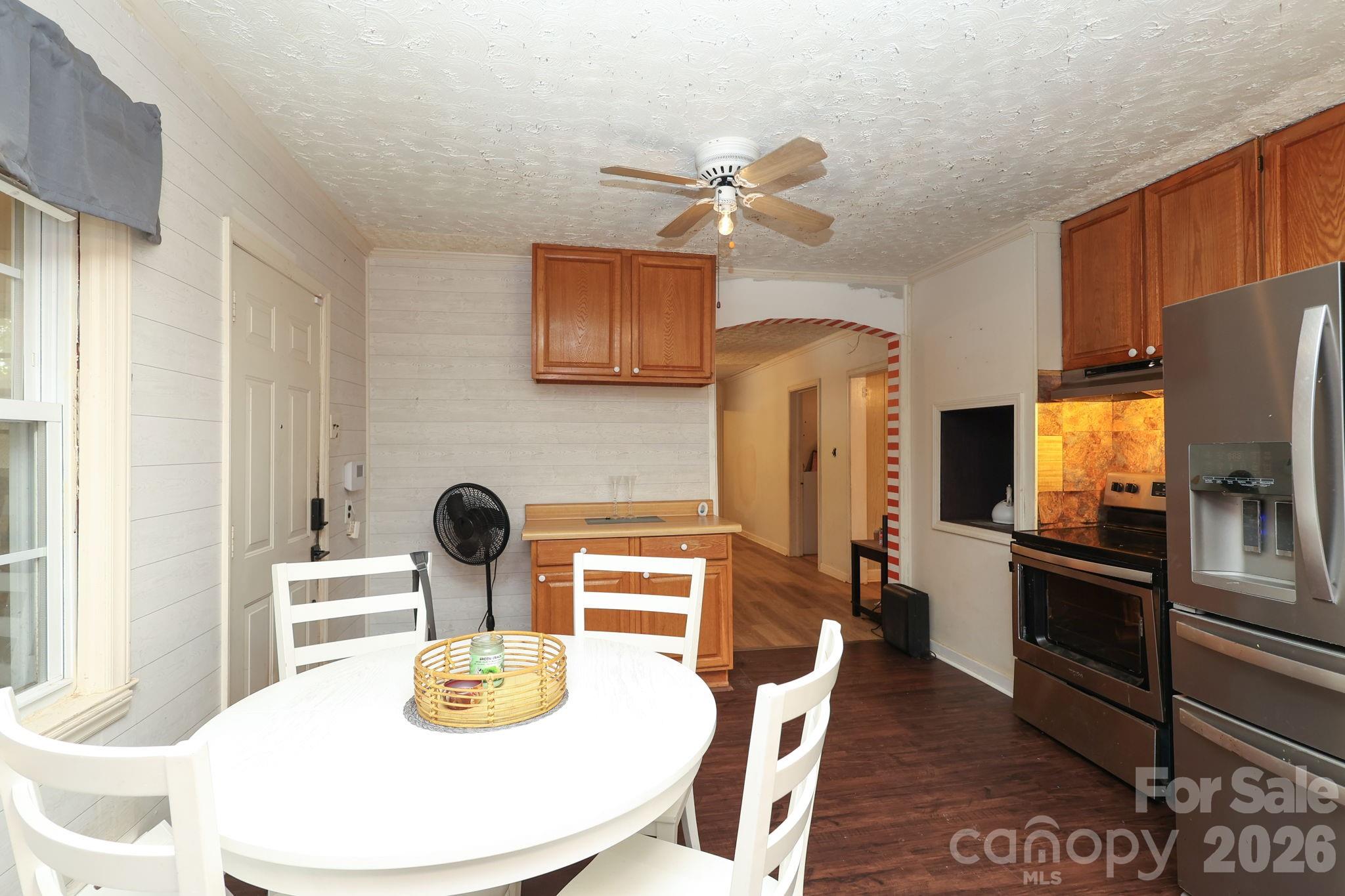 1324 State Rd S-29-496 Lancaster, SC 29720 - Photo 6 of 28 a kitchen with stainless steel appliances kitchen island granite countertop a table chairs and a refrigerator