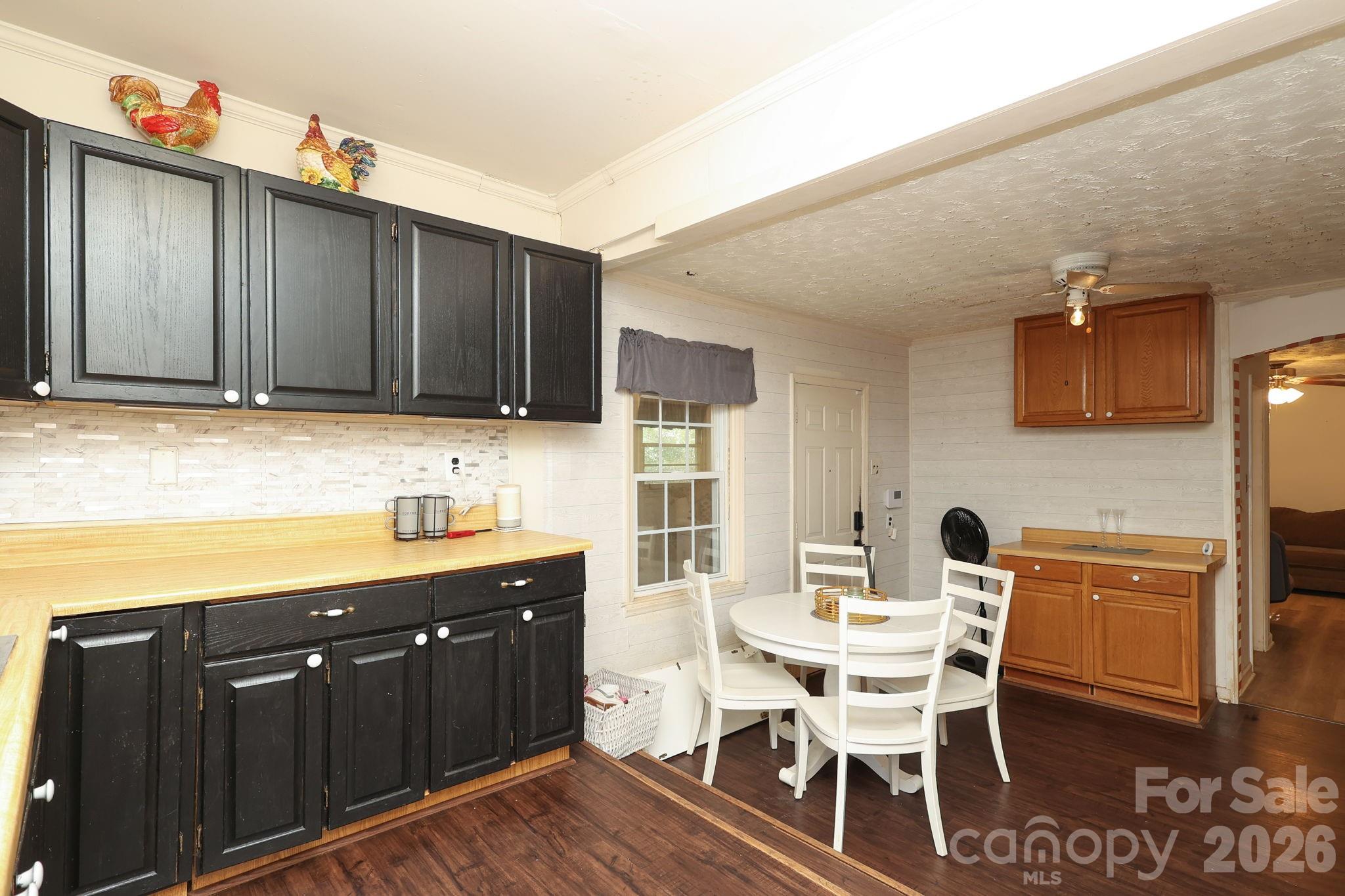 1324 State Rd S-29-496 Lancaster, SC 29720 - Photo 8 of 28 a kitchen with granite countertop a dining table chairs cabinets and stainless steel appliances
