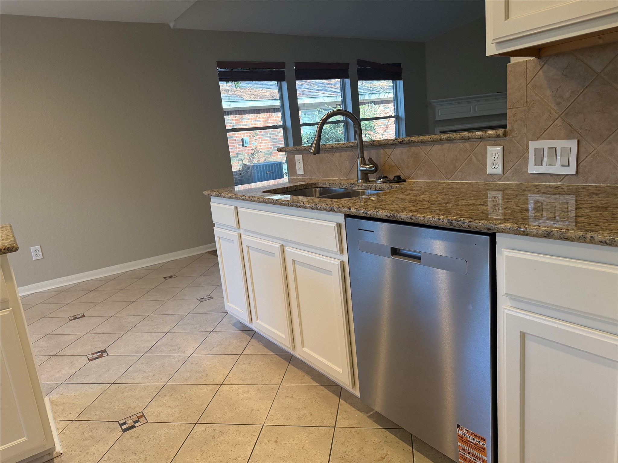58 Shimmer Pond Place Conroe, TX 77385 - Photo 16 of 35 a kitchen with granite countertop a sink a stove and a refrigerator
