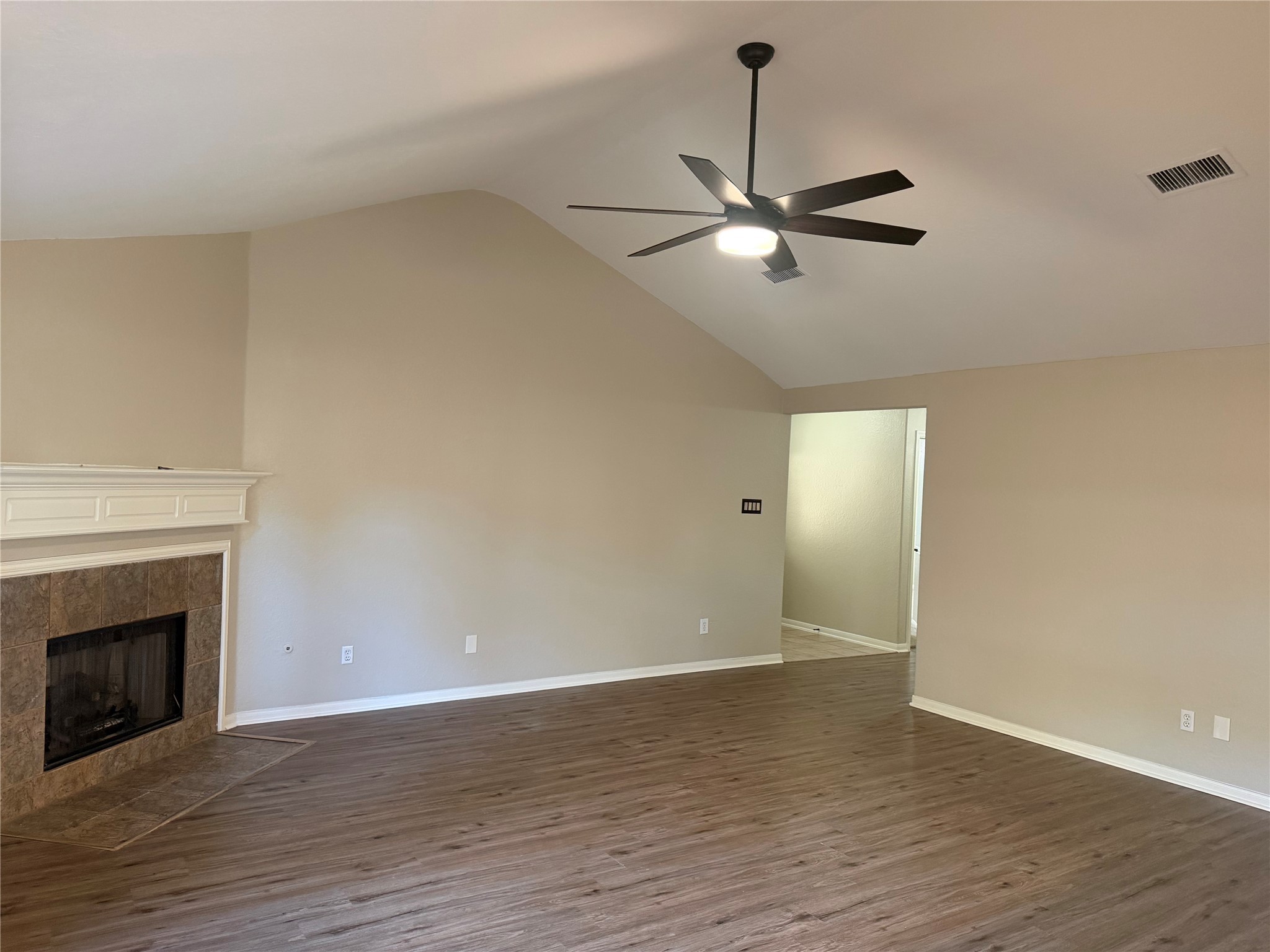 58 Shimmer Pond Place Conroe, TX 77385 - Photo 8 of 35 a view of an empty room with wooden floor fireplace and a window