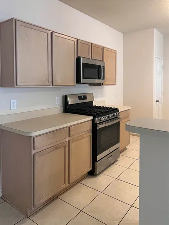 a kitchen with stainless steel appliances granite countertop a sink and a refrigerator