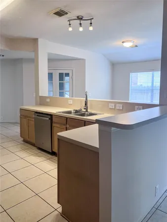a kitchen with granite countertop a sink and a stove top oven