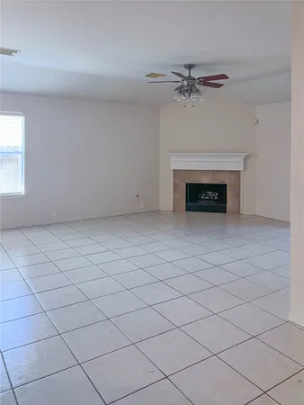 a view of an empty room with a fireplace