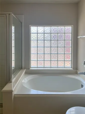 a bathroom with a bathtub and window