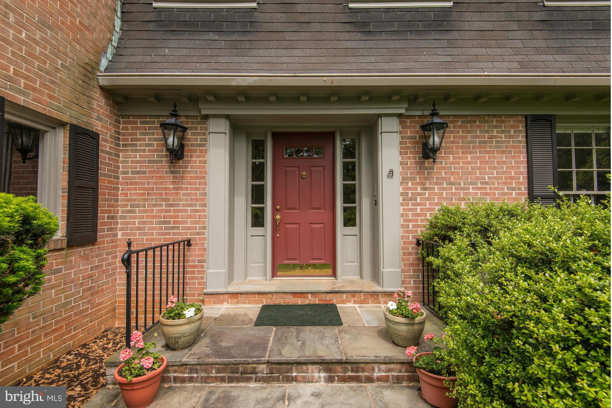 912 Kimberwicke Road McLean, VA 22102 - Photo 2 of 30 a front view of a house with a garden