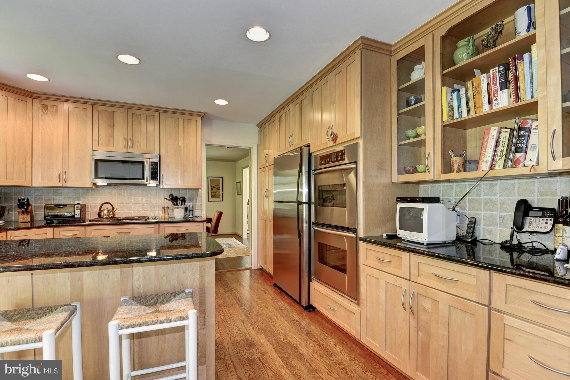 912 Kimberwicke Road McLean, VA 22102 - Photo 11 of 30 a kitchen with stainless steel appliances granite countertop a refrigerator a stove and a sink