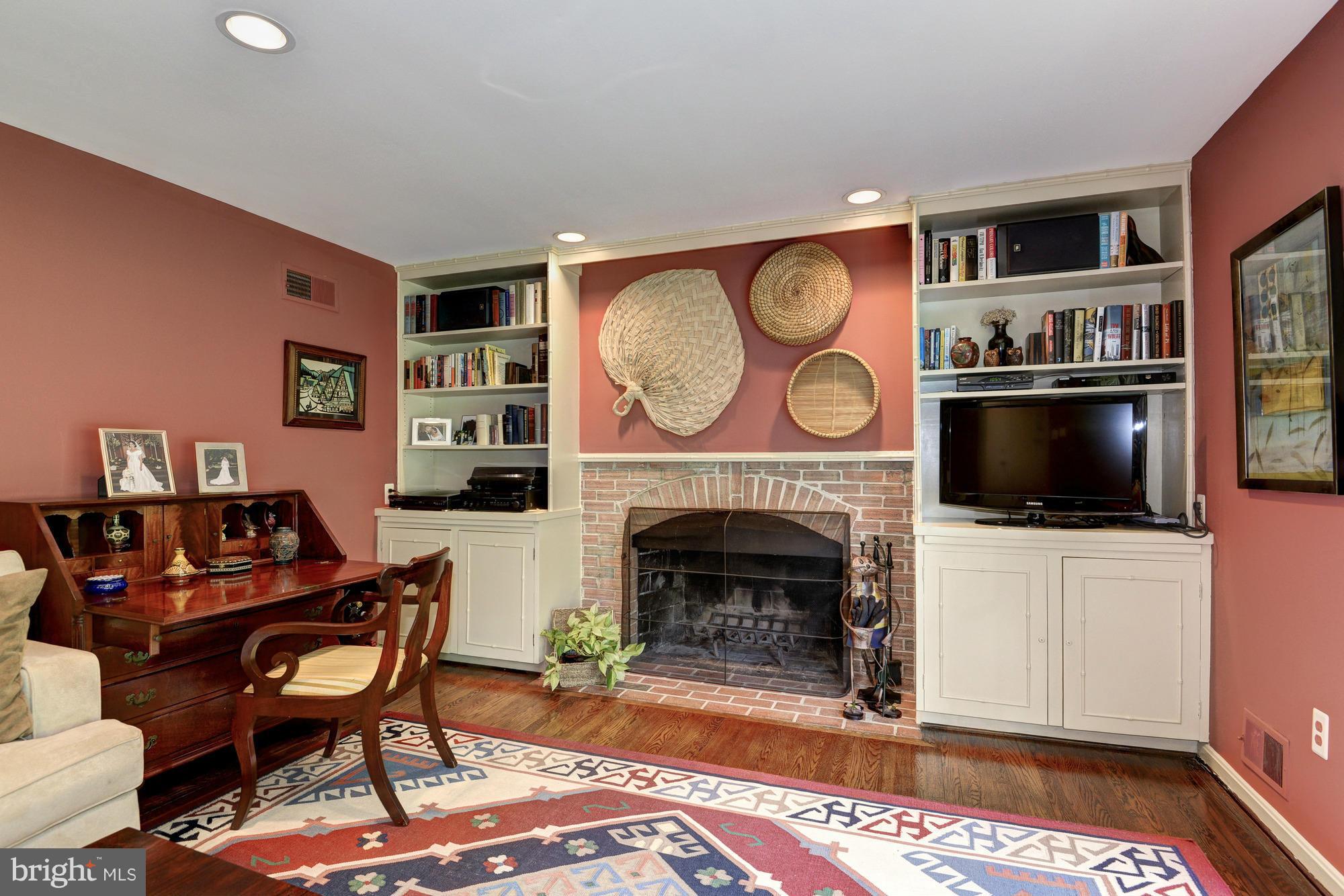 912 Kimberwicke Road McLean, VA 22102 - Photo 15 of 30 a living room with furniture a flat screen tv and a fireplace
