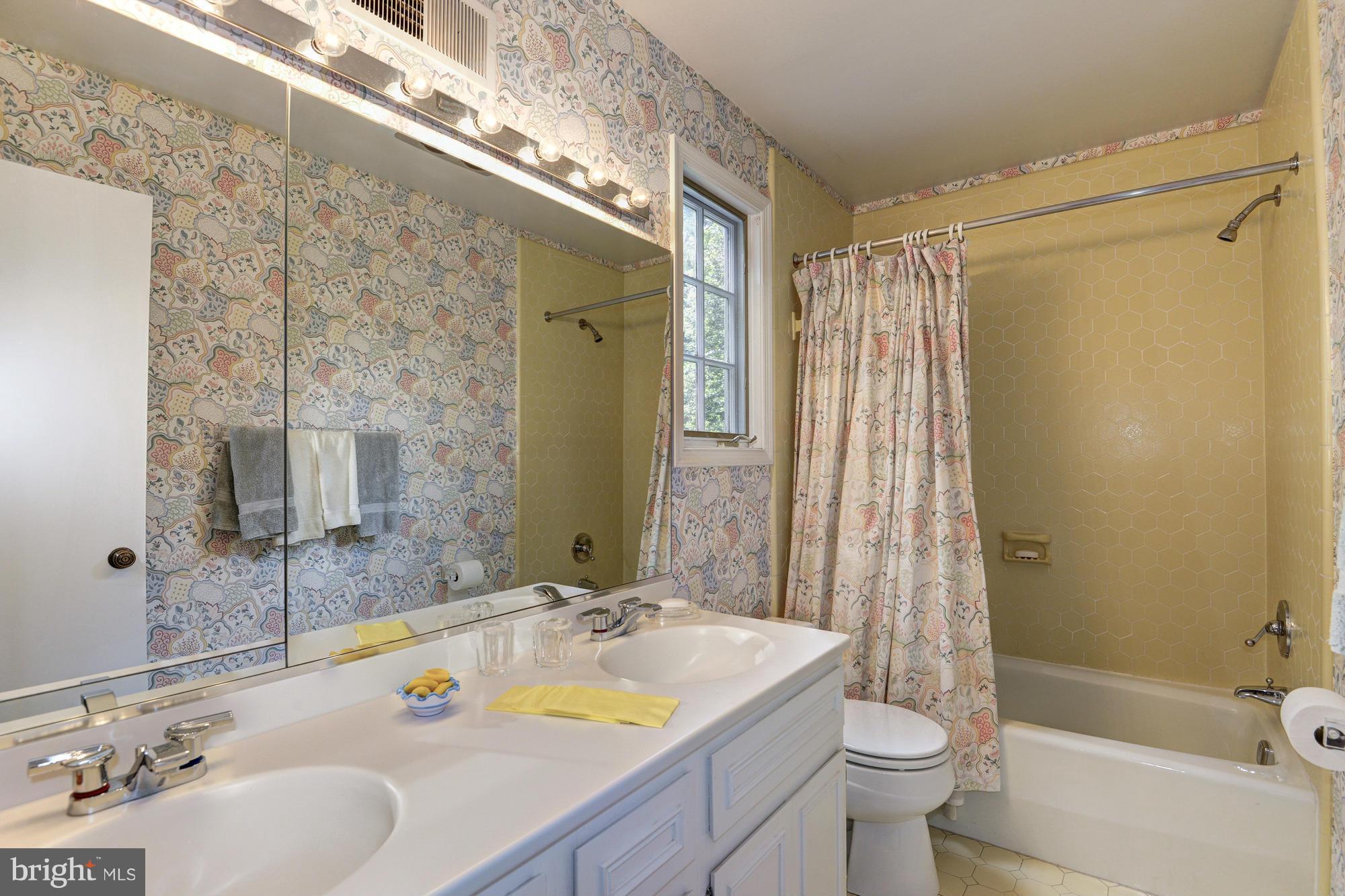 912 Kimberwicke Road McLean, VA 22102 - Photo 25 of 30 a bathroom with a granite countertop sink toilet and shower