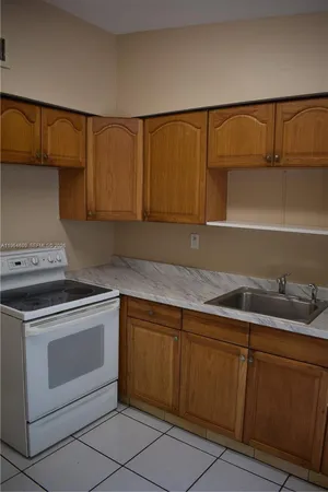 a kitchen with granite countertop cabinets and sink