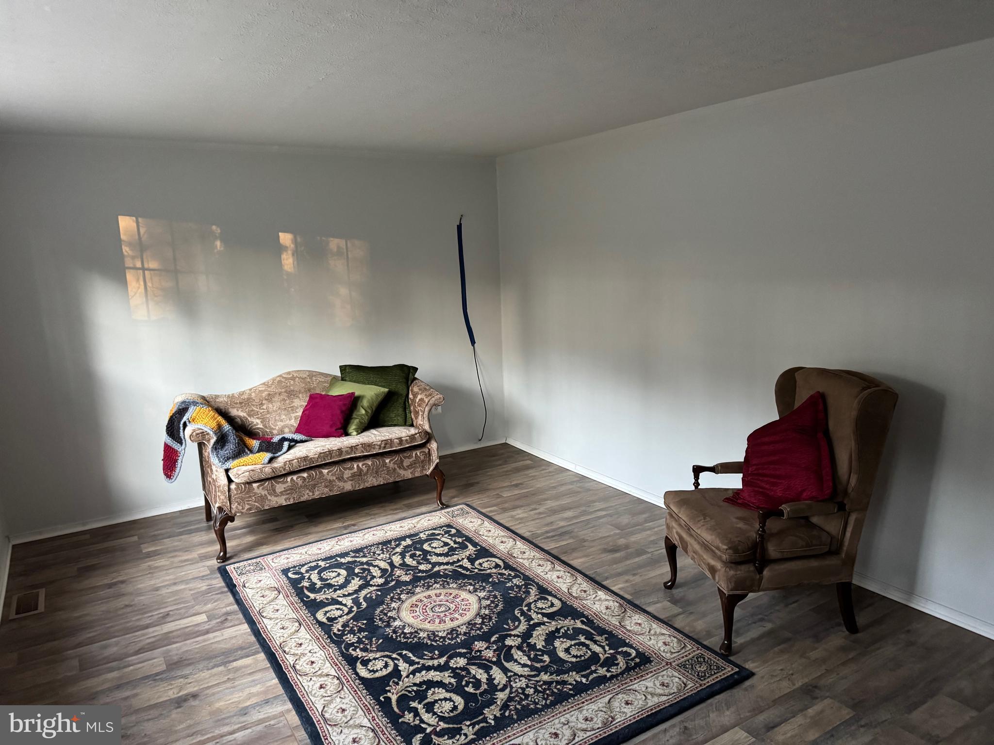 12924 Rousby Hall Road Lusby, MD 20657 - Photo 7 of 15 a living room with furniture and a rug