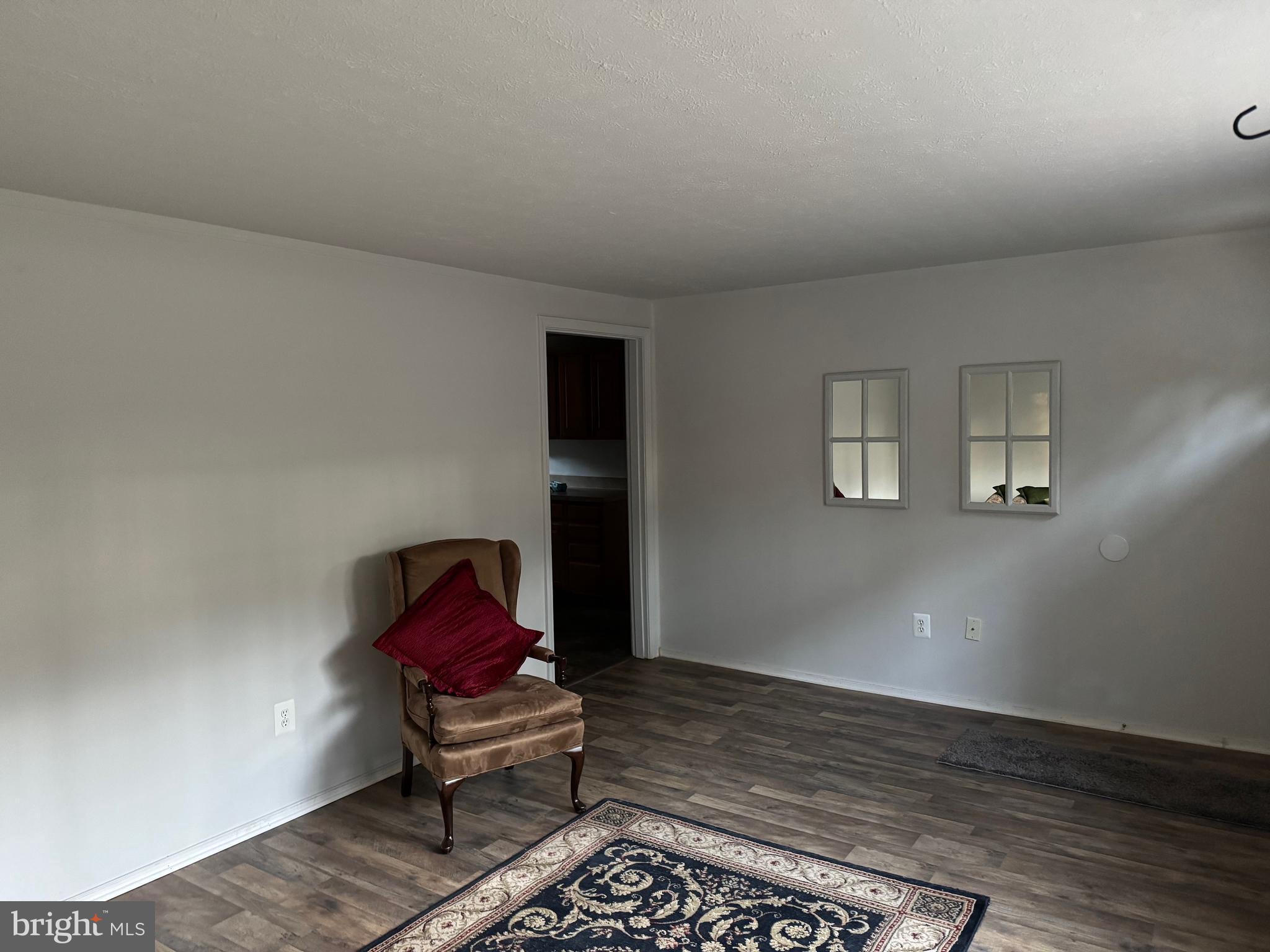 12924 Rousby Hall Road Lusby, MD 20657 - Photo 8 of 15 a living room with furniture and a rug